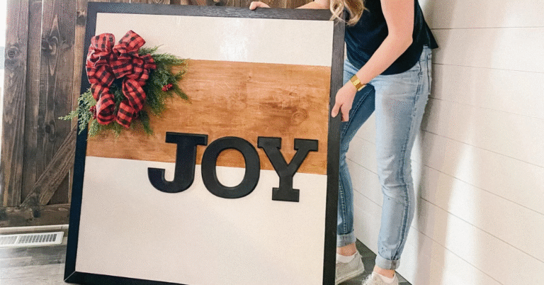 Woman holding DIY Christmas Porch Sign that says Joy