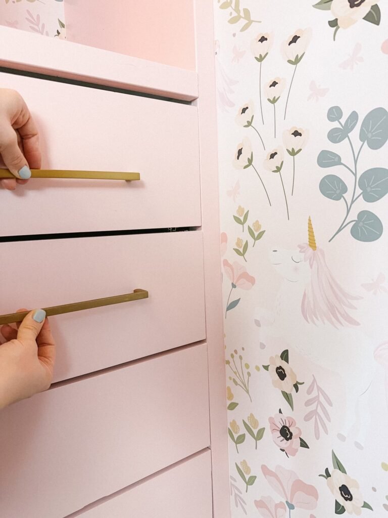 Gold drawer pulls in girls pink walk-in closet