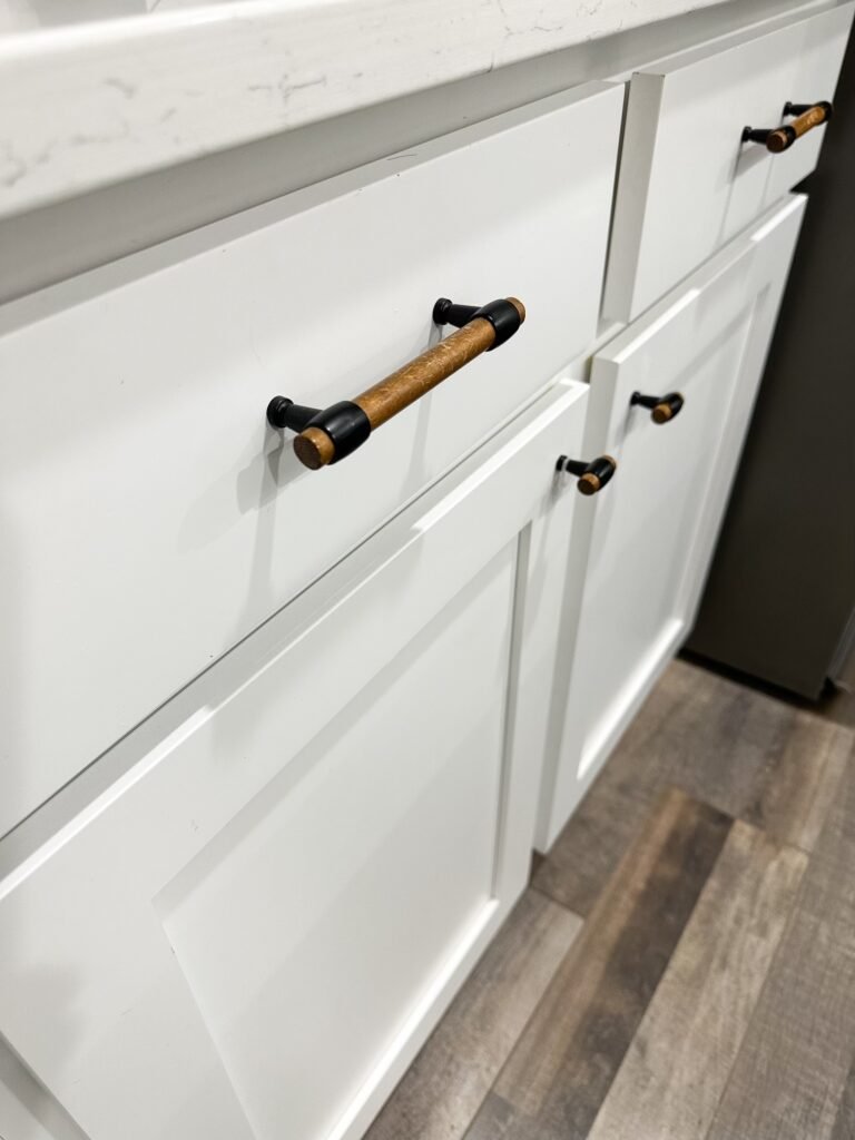 Affordable kitchen updates: adding new hardware. This hardware is a pine and black drawer pull.