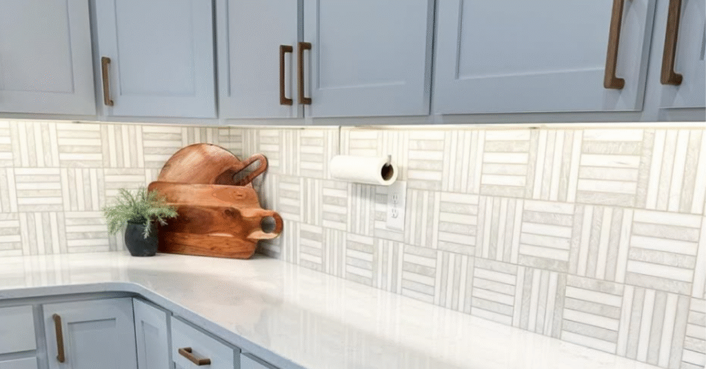 Gray and white striped backsplash with white cabinets