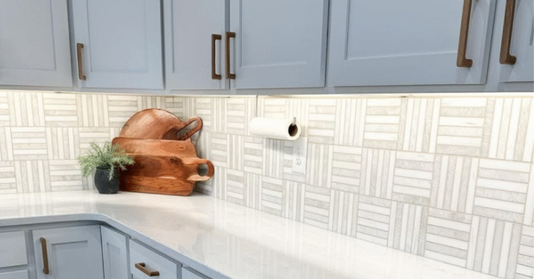 Gray and white striped backsplash with white cabinets