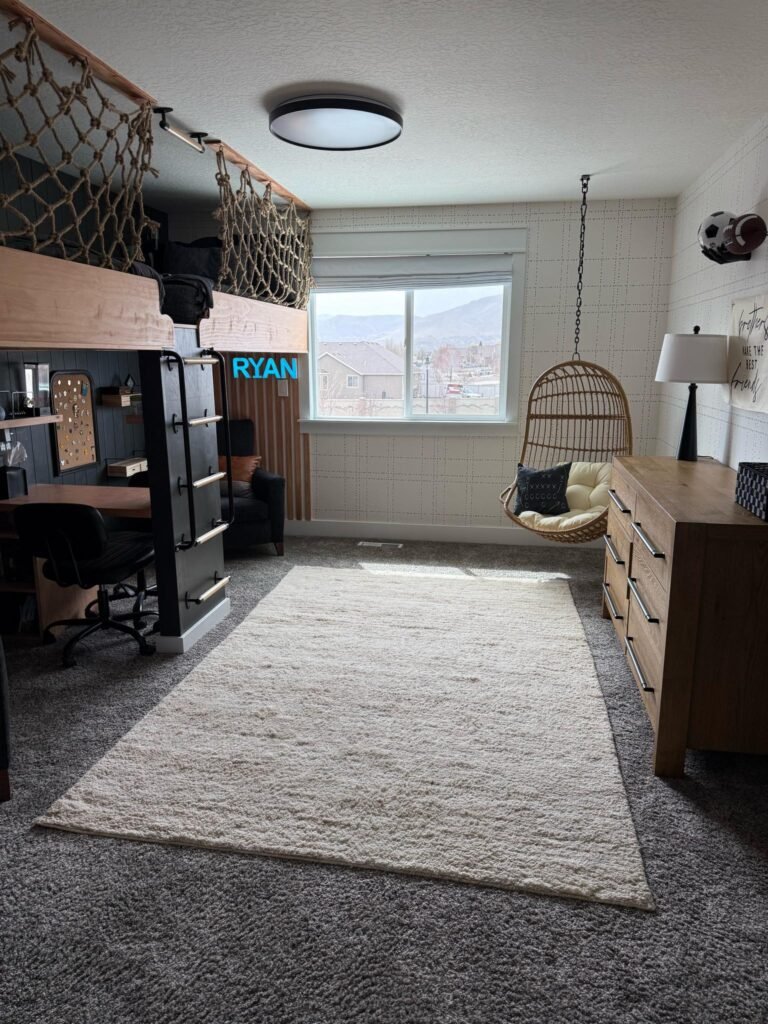 Boys sports bedroom with double loft bed and hanging chair