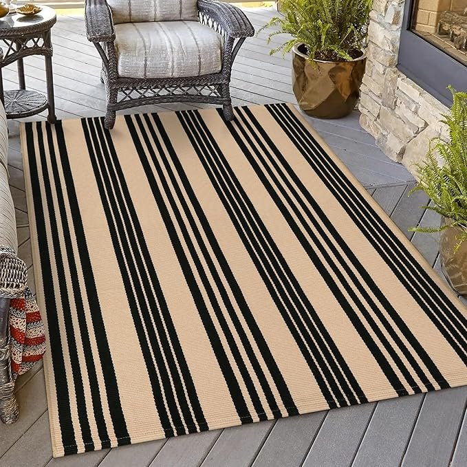 Tan and black striped area rug for front porch on porch with DIY pumpkin arch