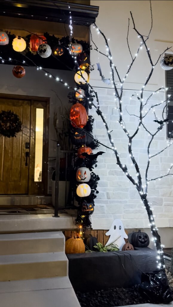 Halloween tree with string lights and hanging bats
