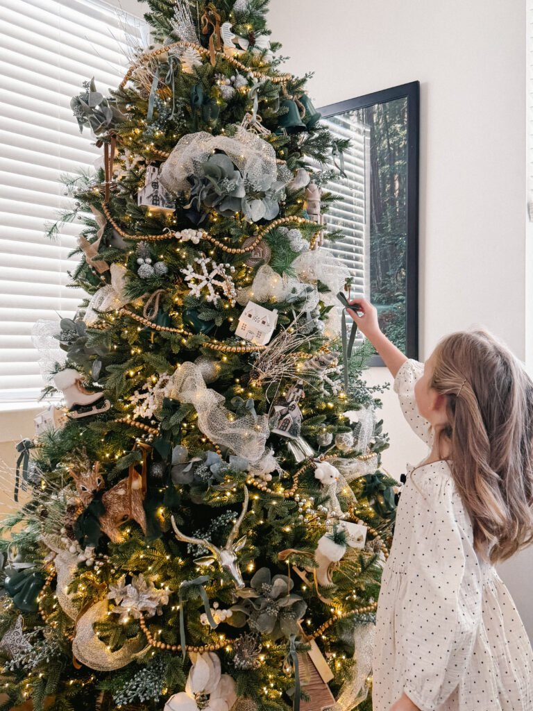Girl decorating Christmas tree