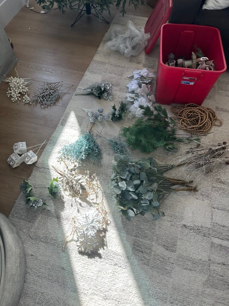 Step 1 of how to decorate a Christmas tree: lay all the ornaments, picks, and garlands out