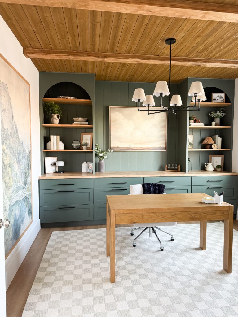 Home office with dark green cabinets and shiplap ceiling