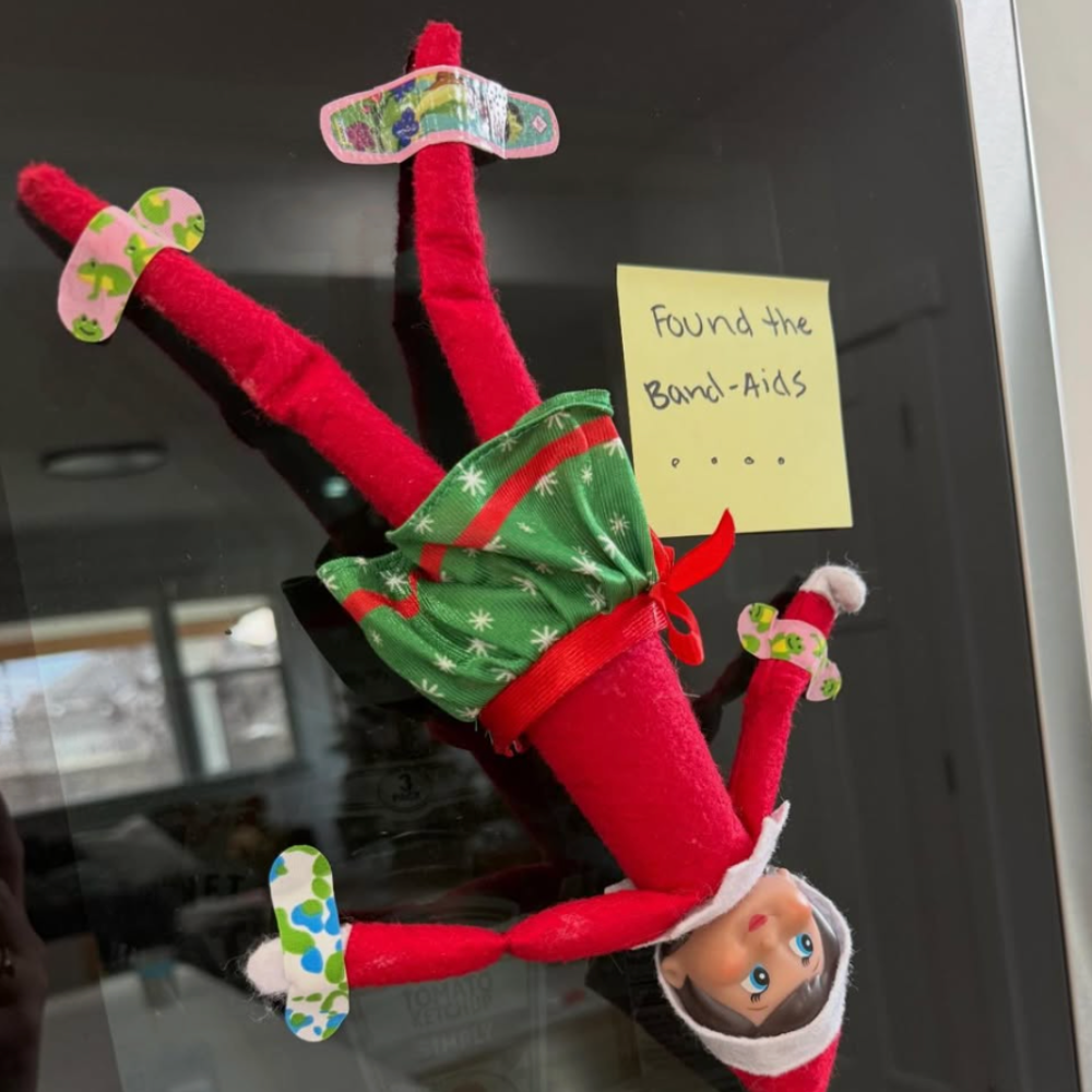 Elf hanging upside down with bandaids