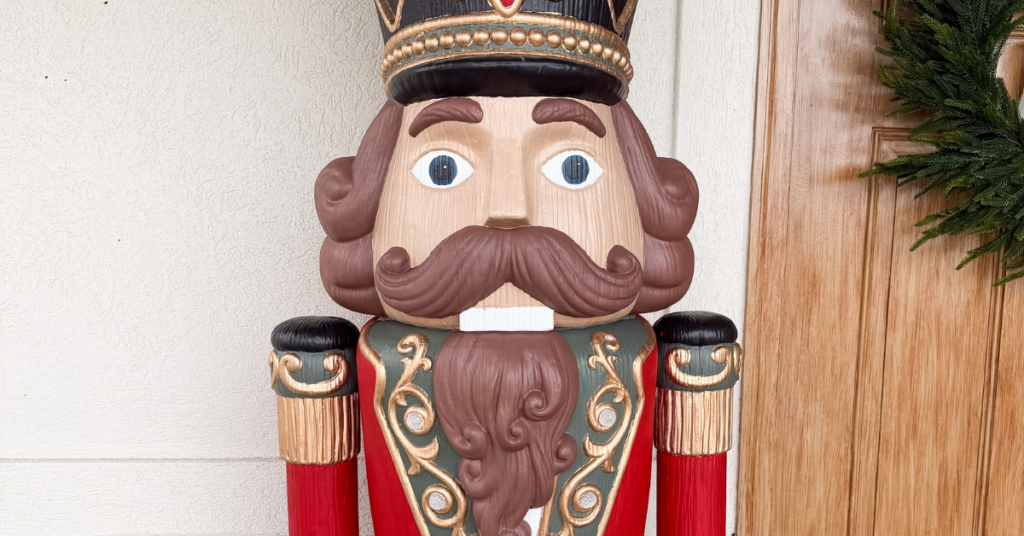 Life-size nutcracker painted red, green, black, and gold