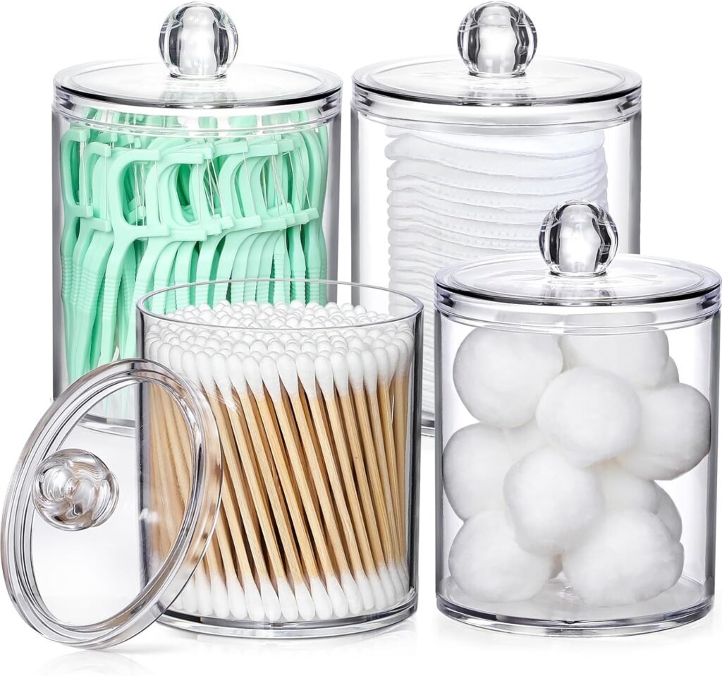 Clear apothecary jars with Q tips, cotton balls, cotton rounds, and floss picks