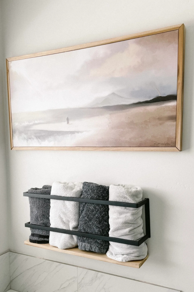 Framed canvas art and black metal/wood towel rack