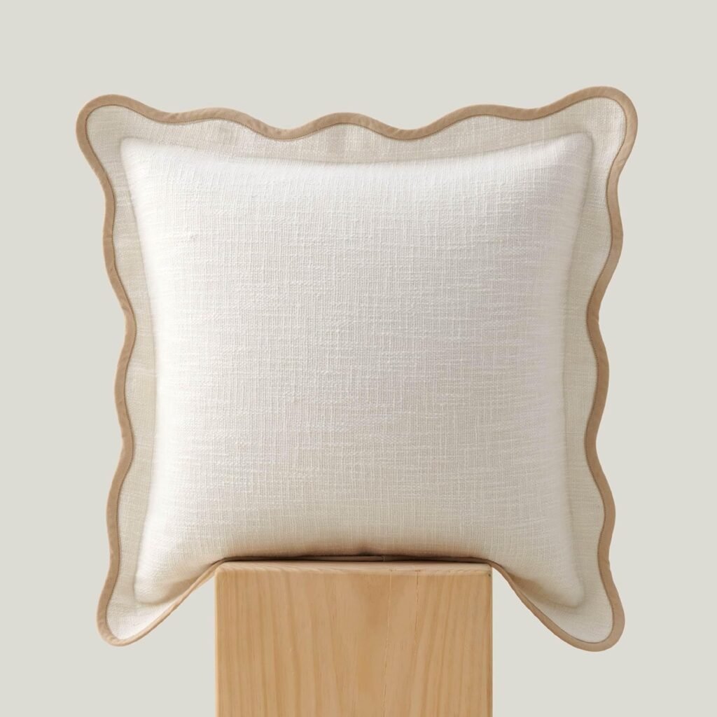 White throw pillow cover with tan scalloped edges