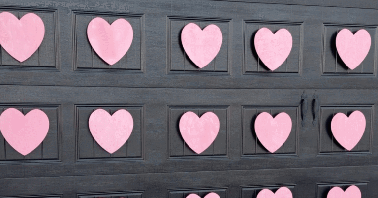 Outdoor Valentine's Decor: Pink wooden hearts on a black garage door