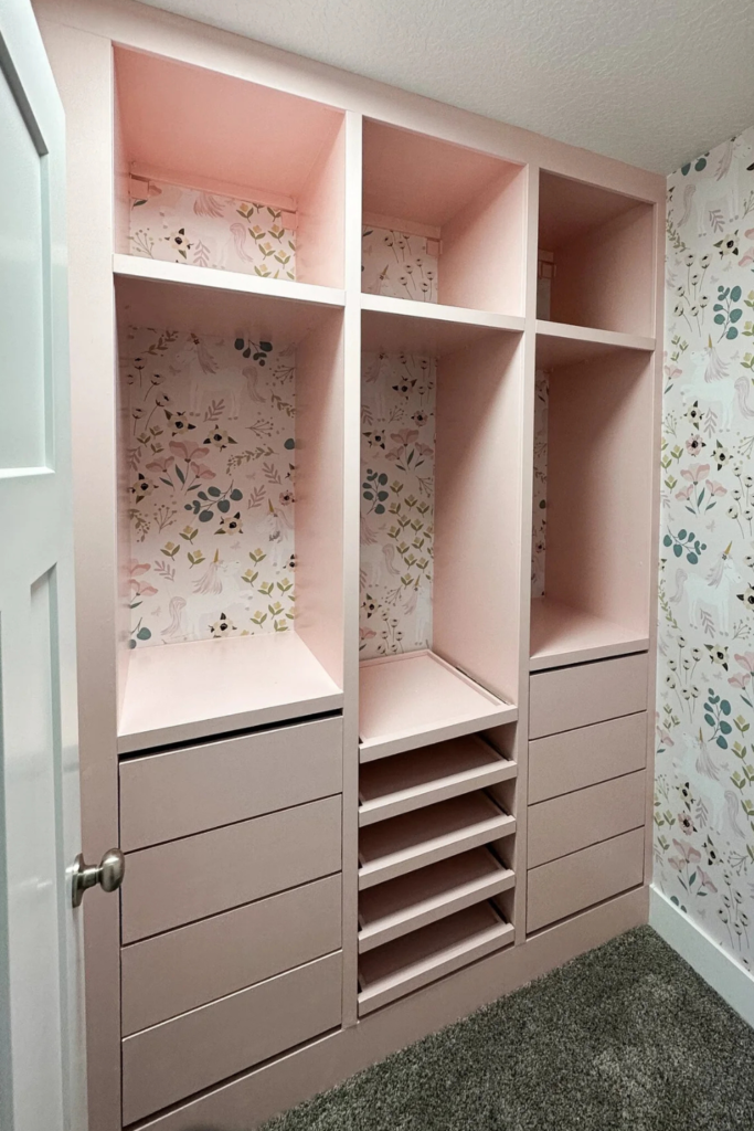 Floral peel and stick wallpaper in walk-in closet with light pink cabinets