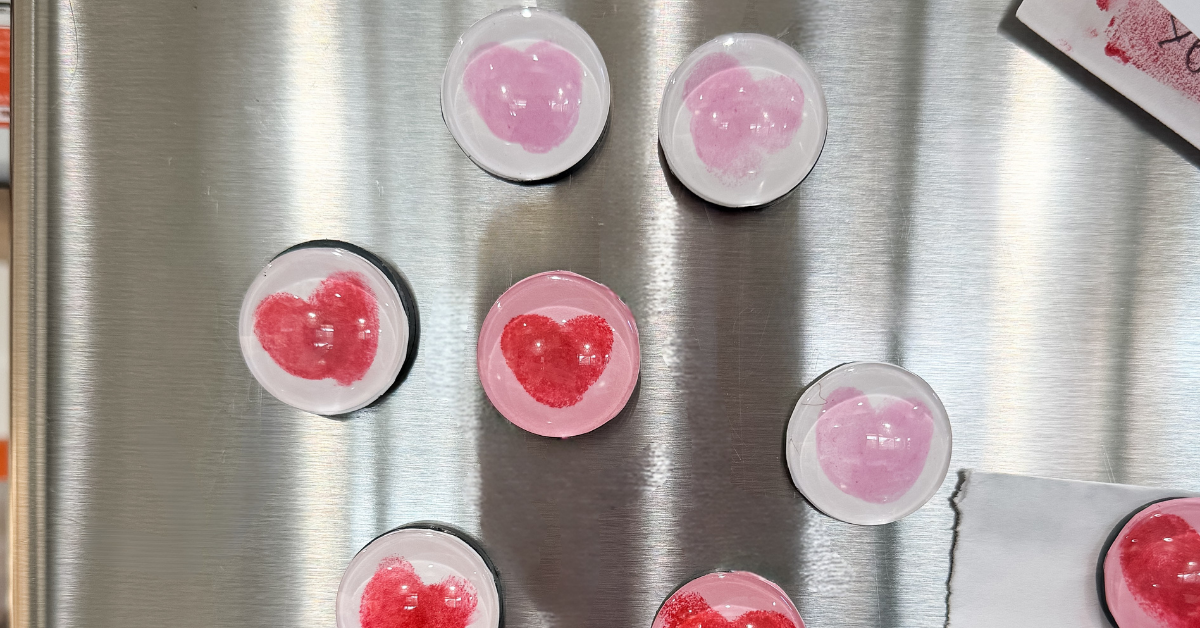 Fingerprint heart magnets on a stainless steel refrigerator