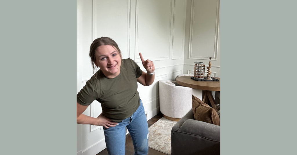 Woman standing in front of picture frame moulding in a living room