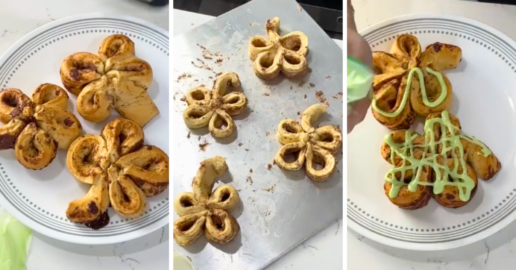 Shamrock cinnamon rolls with green frosting on a white plate and baking sheet