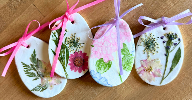 Clay Easter eggs with dried pressed flowers, decoupage napkins, and pink and purple ribbons