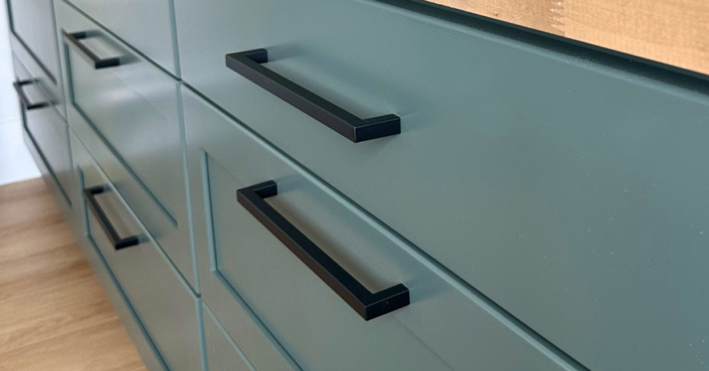 Dark green cabinets with black hardware