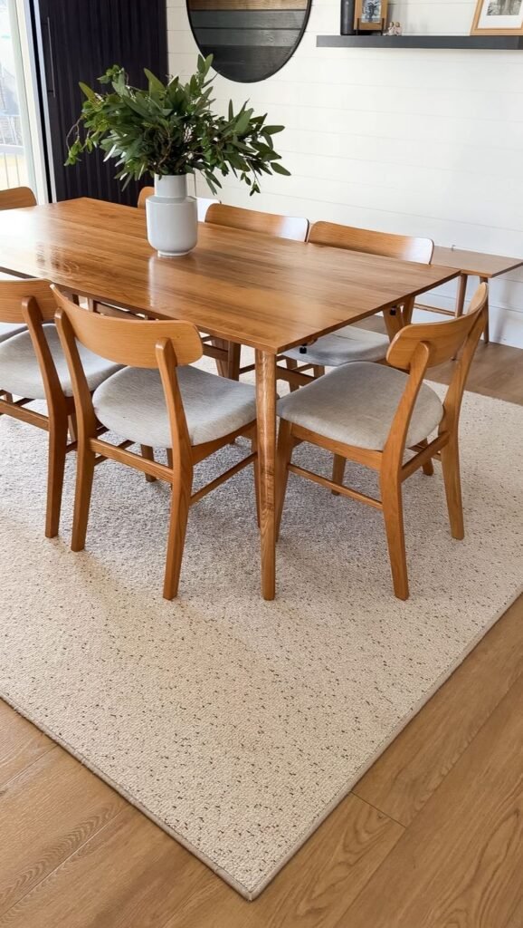 How to Choose a Rug You Love: Our white and gray tufted dining room rug sits under a mid-century modern wood table and chairs