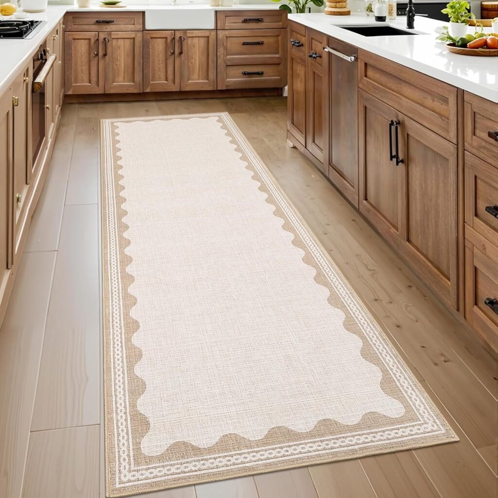 Scalloped border white and tan kitchen runner, wood cabinets with black hardware, white counters