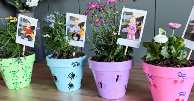 DIY Mother's Day Crafts idea: brightly painted flower pots with fingerprint art. Kid's photos attached to a craft stick in the plant's soil