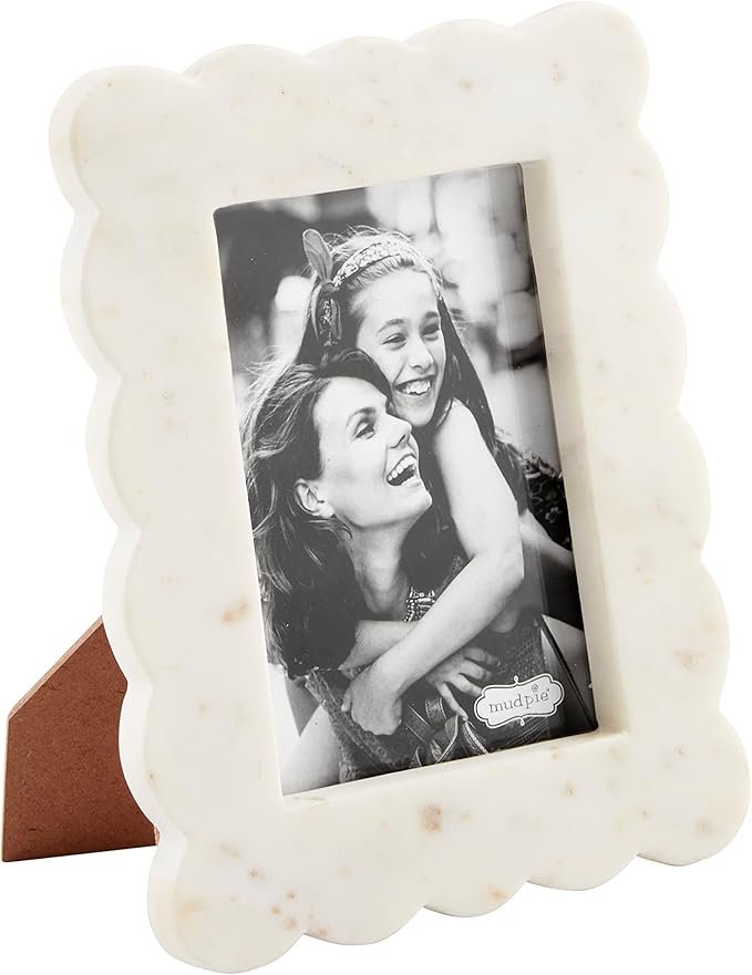 Shelf styling idea: marble scalloped picture frame with smiling mom and daughter photo