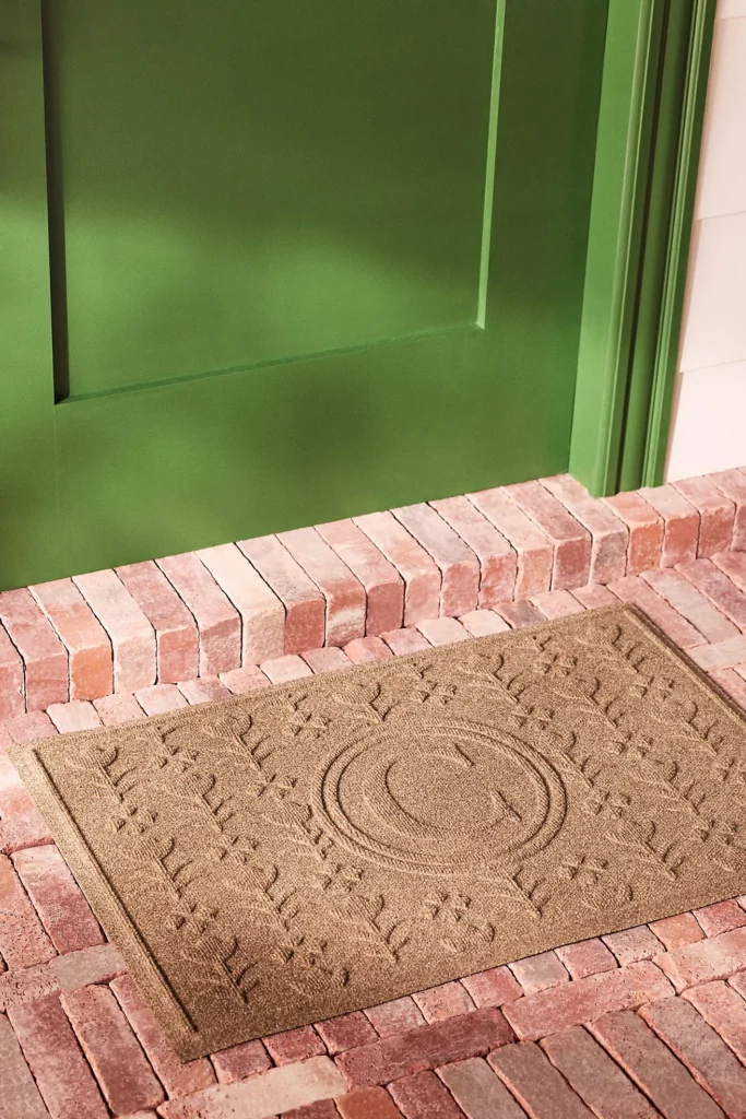 Doormat with monogram initial in the middle and embossed flowers