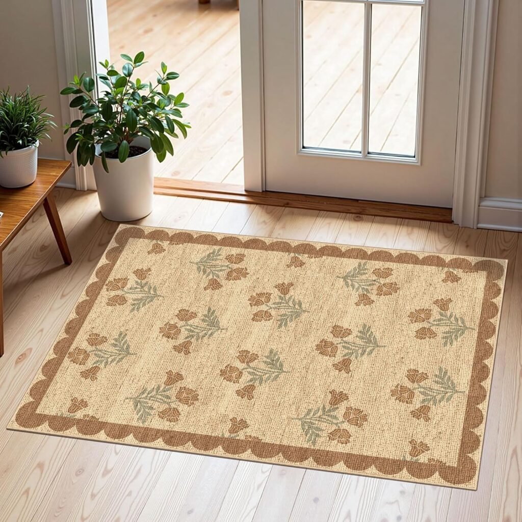 Rug with scalloped dark tan border and tan and green flowers in the middle, beige background
