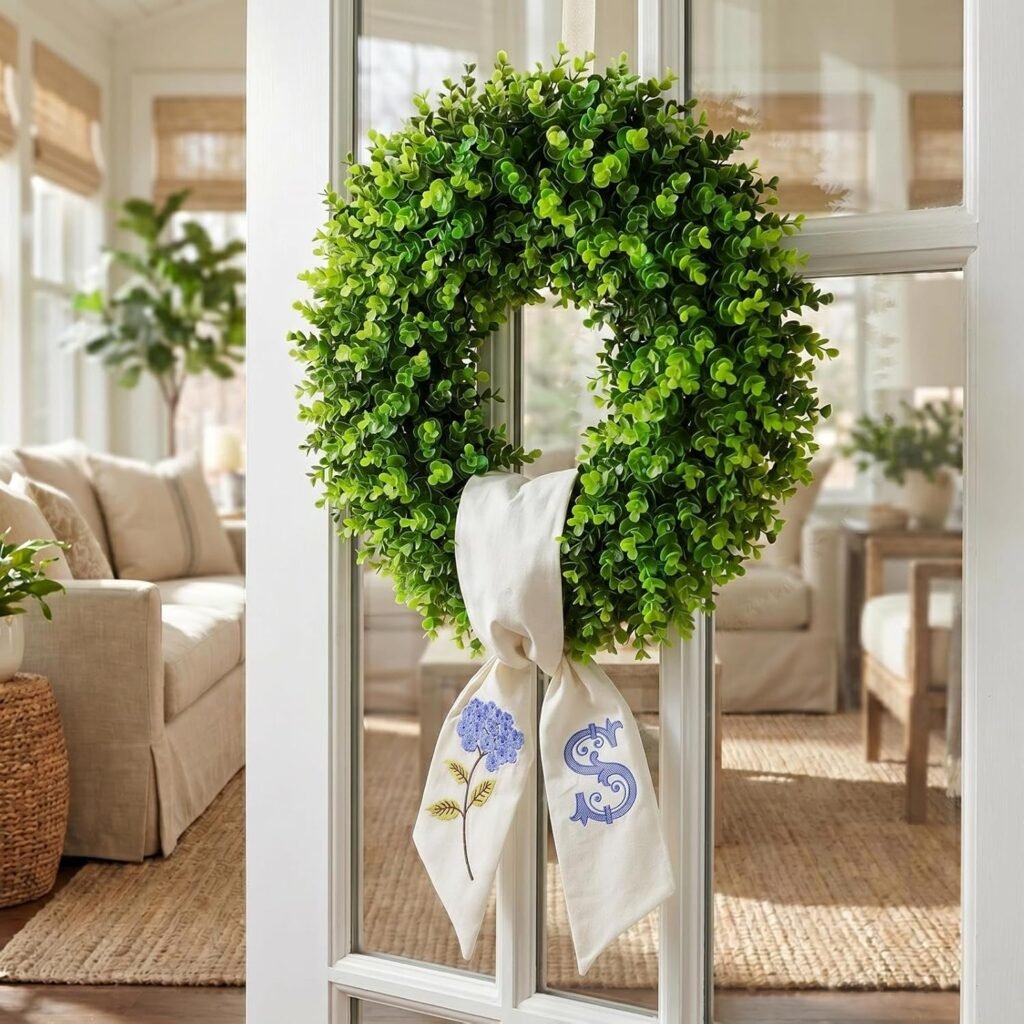 Green boxwood wreath with ribbon hanging on French doors