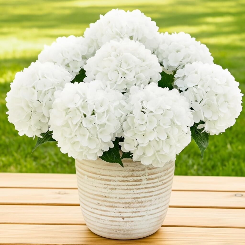 Faux white hydrangeas in a rustic white planter for a spring porch makeover