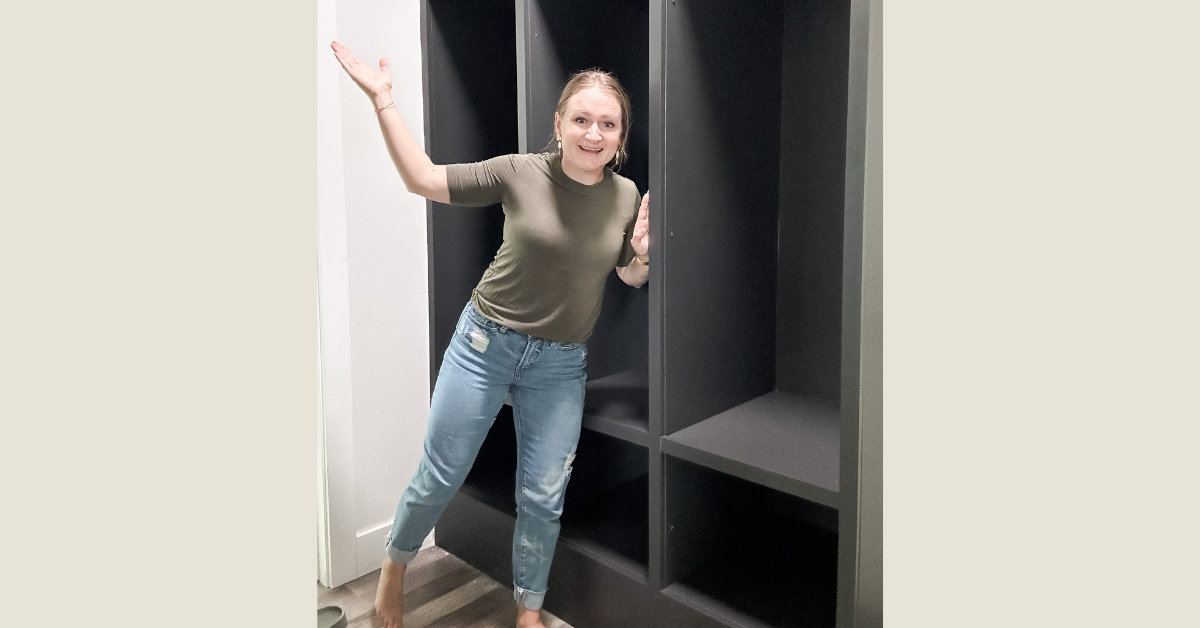 How to make DIY look professional tip: fill in nail holes! Woman standing in front of black open lockers with filled-in nail holes