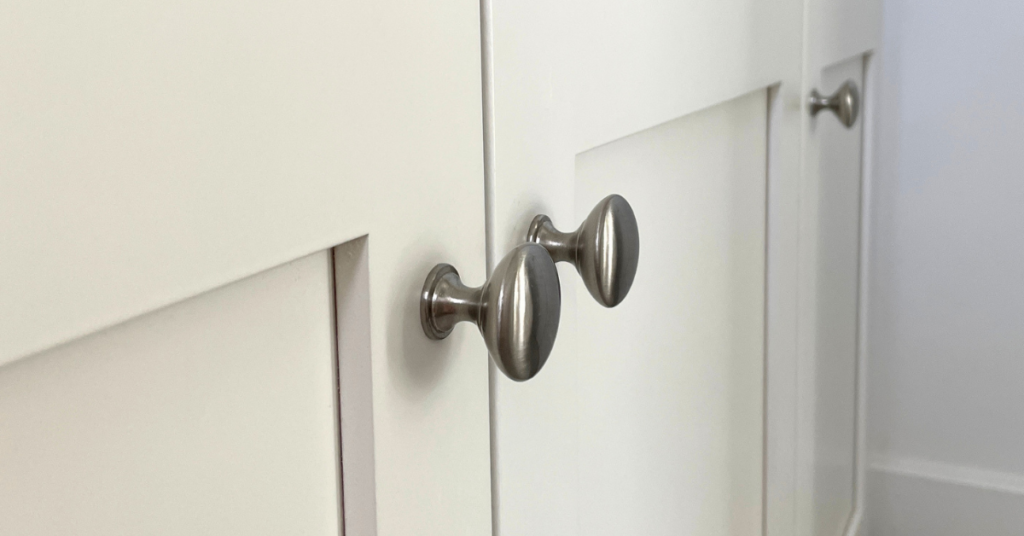 Brushed silver round cabinet pulls on white cabinets