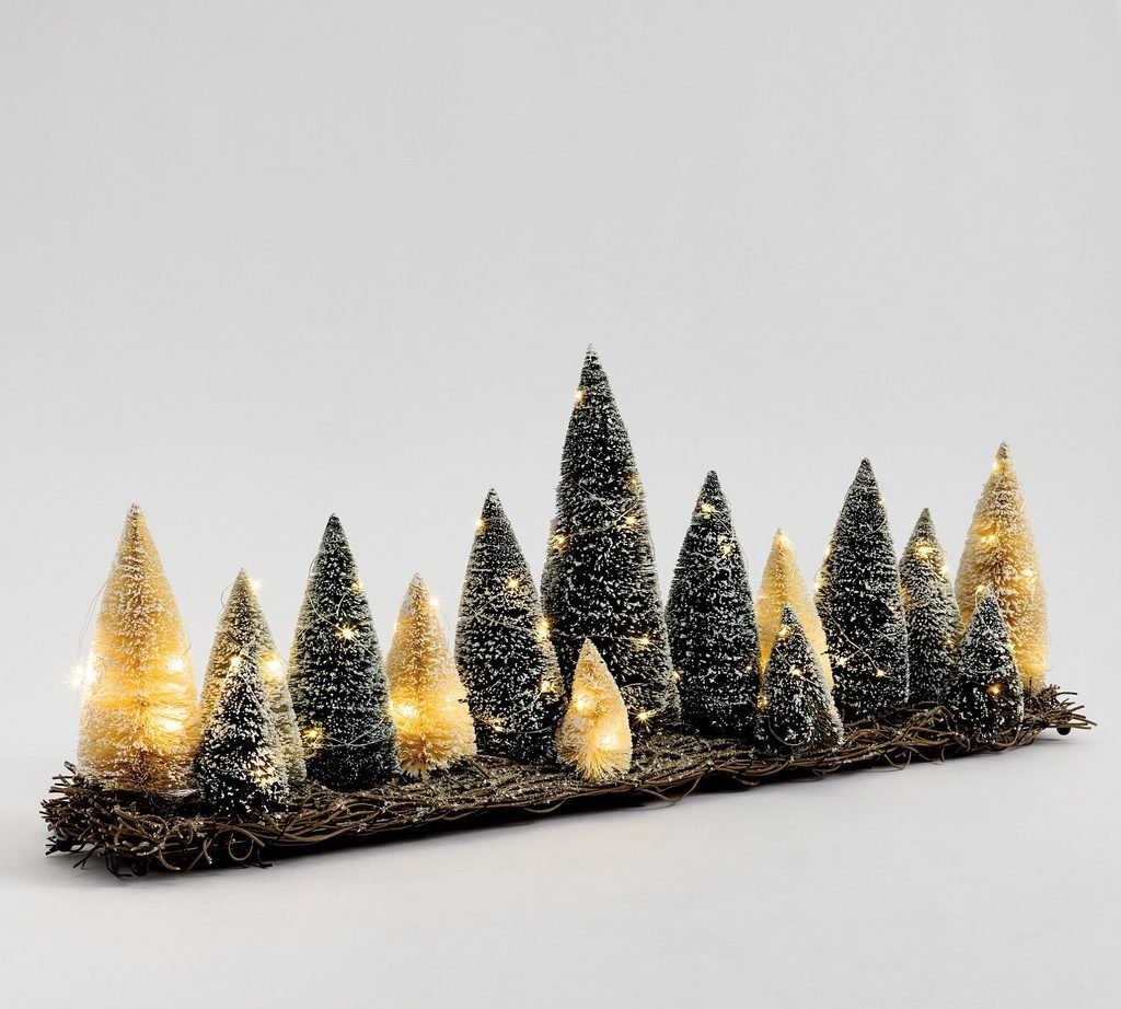 Lit bottlebrush Christmas trees in a wooden tray for mantel decor