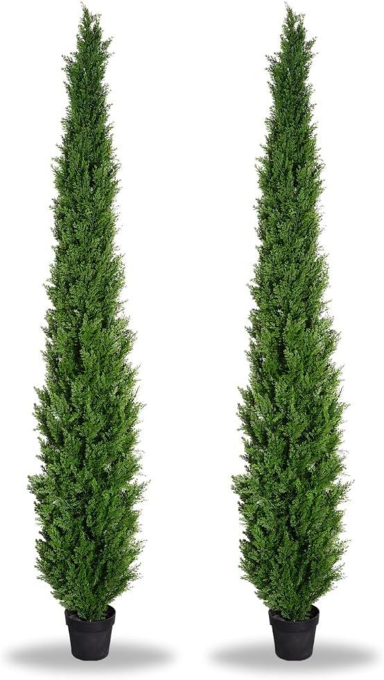 Tall faux green trees provide privacy on the patio transformation