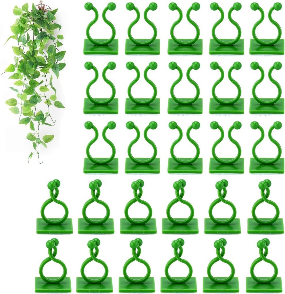 Green self-adhesive plant vine clips and a hanging faux vine for a DIY mud kitchen backdrop