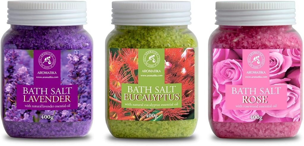 Three jars of scented bath salts in purple, green, and pink 